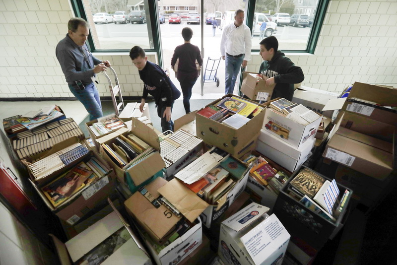 Dartmouth Middle School eighth graders load up a van with the over 10,000 books they collected to donate to Gifts to Give as part of their book drive.  The drive which was held over three weeks, is run as a competition between homerooms and grade levels, with the winning homeroom collecting over 4,000 books.   PHOTO PETER PEREIRA