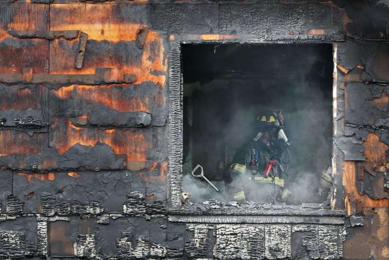 New Bedford firefighters battle a fire at a single family home on Tremont Street in New Bedford, MA. PHOTOS PETER PEREIRA