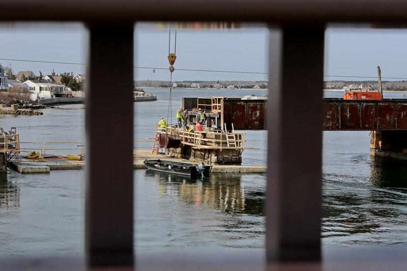 Work crews replace the steel sections of the rail bridge crossing Buttermilk Bay, as seen from the recently re-constructed bridge on Route 6 in Wareham, MA    PHOTO PETER PEREIRA