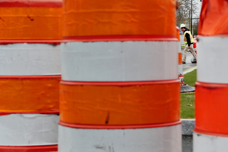 P.A. Landers workmen move the orange barrels into place to block two lanes on Route 18 northbound in downtown New Bedford, in preparation for re-pavement work which will occur over the next couple of days. PHOTO PETER PEREIRA