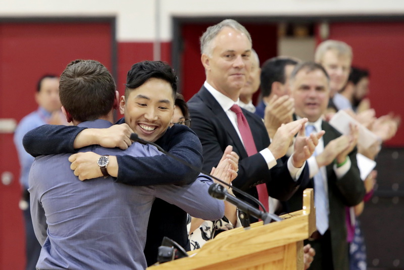 New Bedford High School teacher, Takeru Nagayoshi is congratulated by former student Joshua Correia, 18 senior, after he was named the Massachusetts 2020 Teacher of the Year, at a ceremony held in the high school's gym.    PHOTO PETER PEREIRA