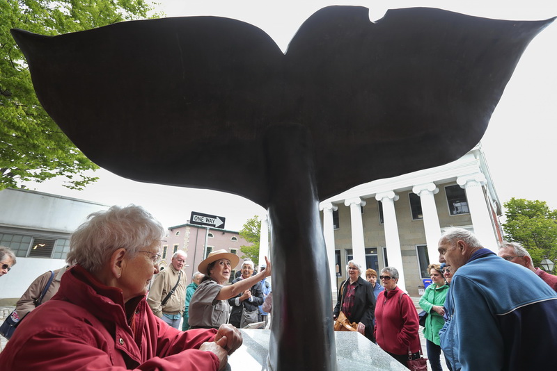 New Bedford Whaling National Historical Park ranger, Lucy Bly stops tourists in front of the whale-tale sculpture on N Water Street in downtown New Bedford, MA to speak about the city's long history of whaling.     PHOTO PETER PEREIRA