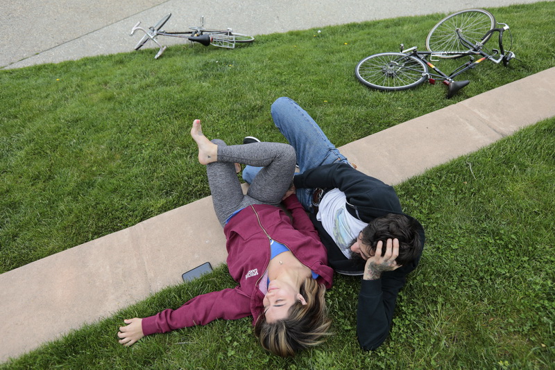 Amanda Ormseth and Garrett Gunderson enjoy each others company and the excellent weather, after riding their bikes to Custom House Square in downtown New Bedford, MA.     PHOTO PETER PEREIRA