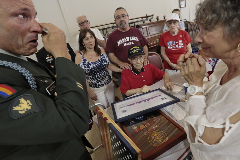 Surrounded by his family, Alfred William Sylvia Jr. 98, looks on as Christopher Azevedo, a veteran of the Navy during Desert Storm, and Army specialist in Iraq, becomes emotional after Mr. Sylvia spoke about a close friend he lost when the USS Dortch was attacked while in Tokyo Bay.  Mr. Azevedo lost close friends while serving in Iraq in 2005. Mr. Sylvia's daughter Dorothy Manny, right, listens to the stories of both men.  Mr. Azevedo who is the president of the Operation Uniforms United organization, which helps veterans with councilling and various other services, was instrumental in having Mr. Sylvia re-awarded his medals at a service held at Oxford Terrace in Fairhaven, MA.    PHOTO PETER PEREIRA