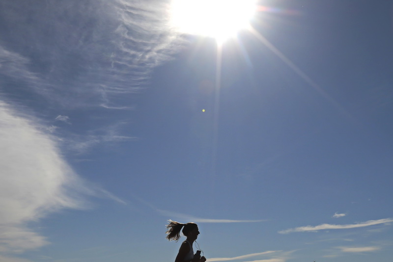 A runner makes her way up Smith Neck Road in Dartmouth, MA on a perfect morning.      PHOTO PETER PEREIRA