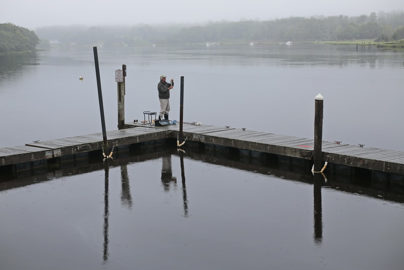 On a rainy, foggy morning, former mayor of New Bedford, John Bullard, who is a Baywatcher for the Buzzards Bay Coalition, volunteers his time to check the quality of the water in the East Branch of the Westport River in Westport.  The Buzzards Bay Coalition has been running this program since 1992 and has more than 800 volunteers checking water quality in 30 major harbors in ten municipalities stretching from Westport around to Falmouth, including the Elizabeth Islands.  PHOTO PETER PEREIRA