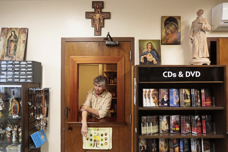 Helen who works at the Sacred Heart Bookstore at Our Lady's Chapel in downtown New Bedford, waits for customers to arrive as the chapel prepares to celebrate Corpus Christi with a procession on Sunday at 2pm.  PHOTO PETER PEREIRA