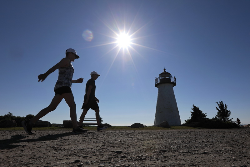 Gary Zahn and wife Dorelle Zahn enjoy the perfect weather to go for their daily walk around the iconic Ned's Point lighthouse in Mattapoisett, MA.   PHOTO PETER PEREIRA