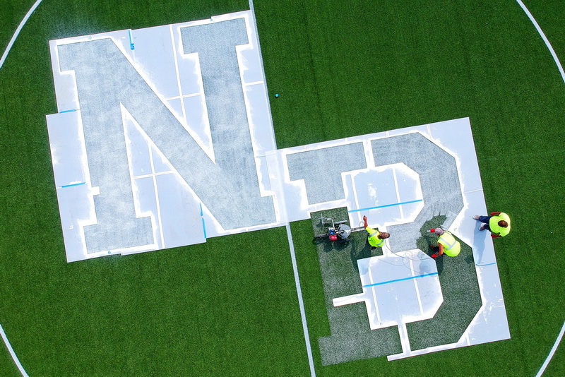 New Bedford DPI's Felix Fernandez leads John Burgo, Arthur Correia & Danny Ortiz re-painting the large NB letters inside the center circle of the soccer field at Riverside Park in the north end of New Bedford, MA.  PHOTO PETER PEREIRA