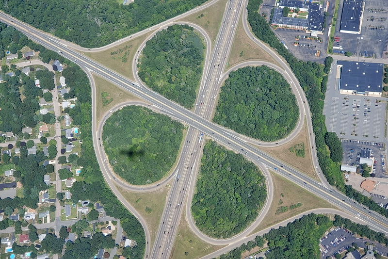 The shadow of a Delta Airlines airplane arriving from Lisbon, Portugal casts its shadow on the cloverleaf exchange between route 24, and route 27 in Brockton as it makes its approach to Logan Airport in Boston, MA. PHOTO PETER PEREIRA