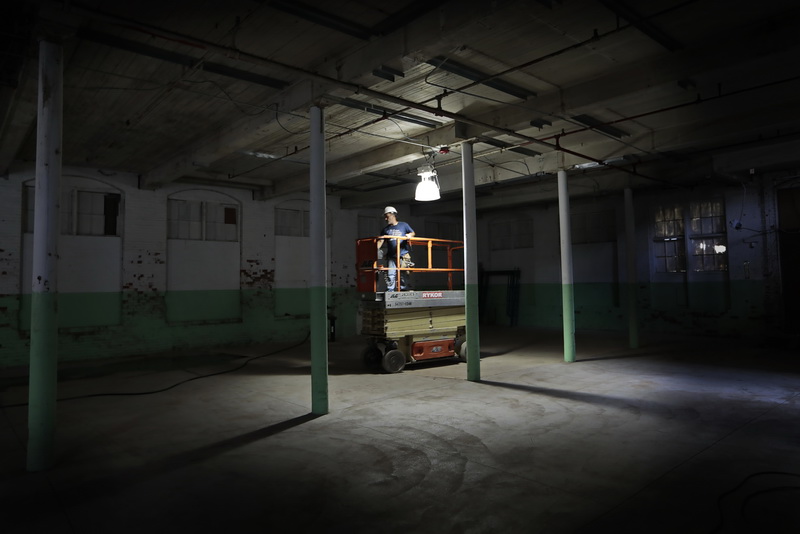 Master carpenter, Mario Abreu drives his lift to the location where he will begin work at the site of thirty three luxury apartments being constructed from an old mill at the Lofts at Wamsutta Place on Wamsutta Street in New Bedford, MA.  PHOTO PETER PEREIRA