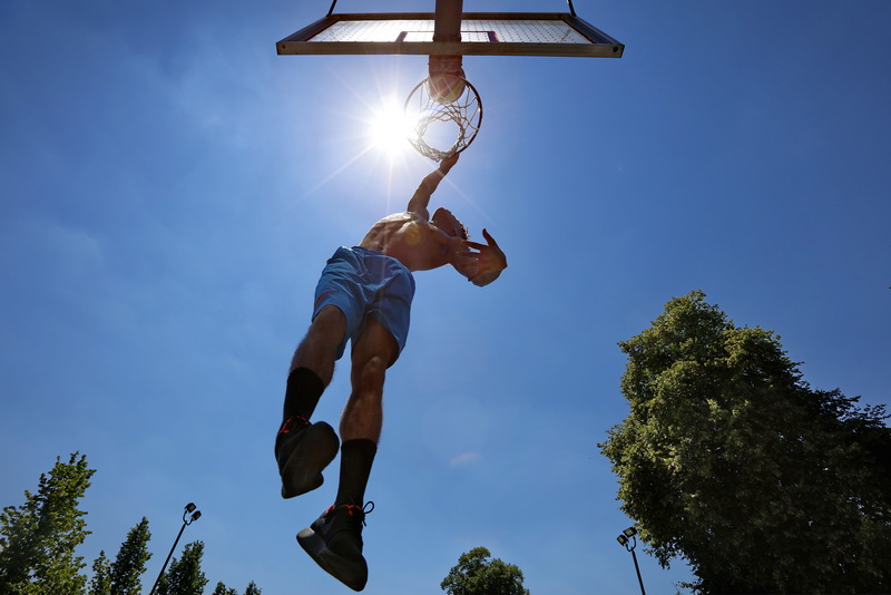 Emanuel Taylor Jr. doesn't let the heat keep him from working on his basketball skills at the Clasky Common Park court in New Bedford, MA  PHOTO PETER PEREIRA