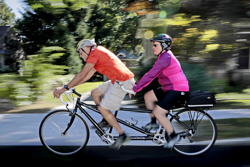 Steve Gillum and wife Donna Gillum pedal their tandem bicycle up Green Street in Fairhaven, MA for a morning ride.   PHOTO PETER PEREIRA