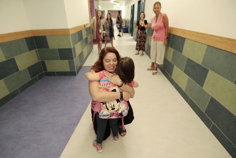 Molly Penney gives Pamela McDermott a hug upon seeing her for the first time, as students return to class at the Irwin Jacobs elementary school in New Bedford for the first day of class.  