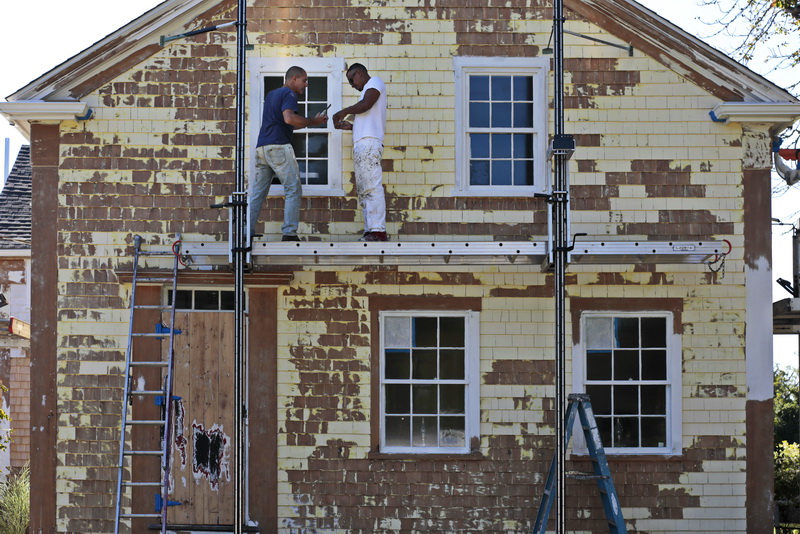 Workmen with Reis Panting prepare a home for a fresh coat of paint in Dartmouth, MA. PHOTO PETER PEREIRA