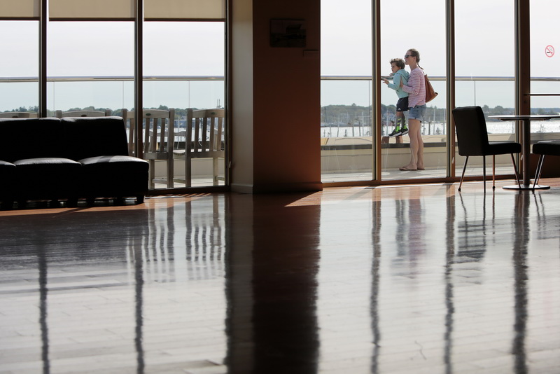 Amy Silva holds up her son Ethan Silva, 4, to take in the view of downtown New Bedford,  from the Harborview gallery on the top floor of the Whaling Museum.  PHOTO PETER PEREIRA