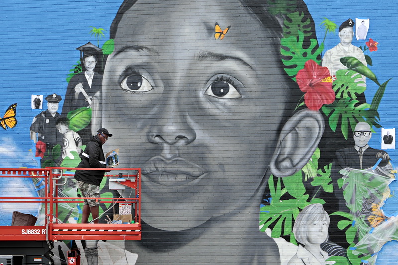 Cedric Douglas works on the mural he is painting on the side of one of the apartments at the Reb Rose housing development in the south end of New Bedford, MA. The subjects seen in the mural all lived at one time or other at the Ben Rose development, and went on to become prominent members of the community. The mural is visible from Route 18 near the Division Street intersection.   PHOTO PETER PEREIRA