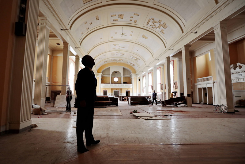 Mayor Jon Mitchell takes a closer look at the inside of the Sant Anne Church, before it is demolished to make way for the future Public Safety Center on Brock Avenue in the south end of New Bedford, MA.  The new Public Safety Center will feature a new fire and police station.   PHOTO PETER PEREIRA