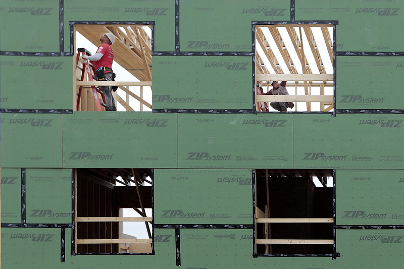 Workmen are seen installing the roof beams on the top level of the future Veterans Transition House on Willis Street in New Bedford, MA.  PHOTO PETER PEREIRA