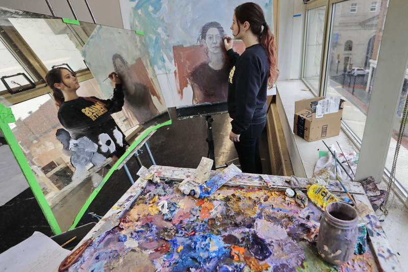 UMass Dartmouth fine arts graduate student, Alex Landry, works on a self portrait at her studio located at the Star Store campus in downtown New Bedford, MA.