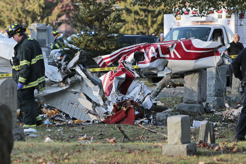 New Bedford fire and police work the scene of a crashed plane at Rural Cemetery in New Bedford, MA.