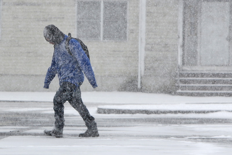 A student fights the elements, as he makes his way to New Bedford High School on a snowy morning.  PHOTO PETER PEREIRA