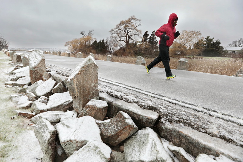 A man braves the freezing weather to go for a run, atop the hurricane barrier at Fort Phoenix in Fairhaven, MA.  PHOTO PETER PEREIRA