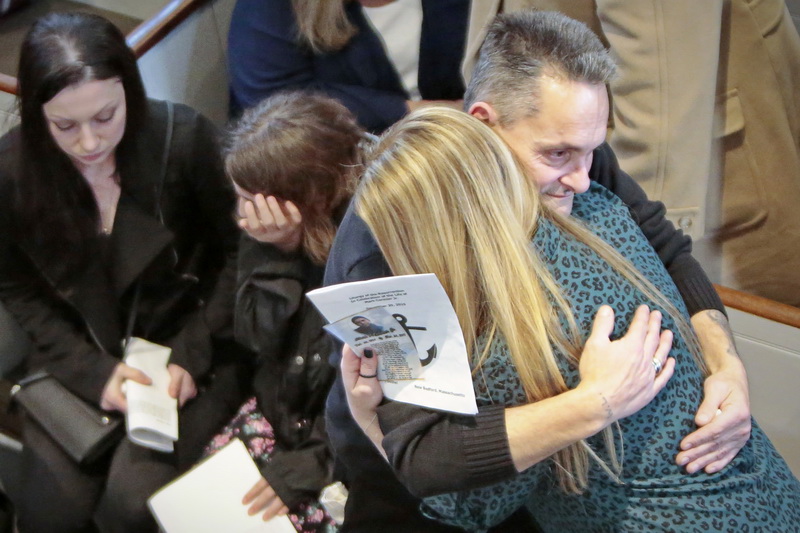 Richard Marques, father of Mark Cormier Jr, and Jeannine Cronin, Mark's fiancee, seek comfort in each other during the service in celebration of Mark's life held at the Seamen's Bethel in New Bedford.  Mark Cormier Jr., 35, along with two other fishermen were lost at sea aboard the New Bedford fishing vessel Leonardo on November 24, 2019.   PHOTO PETER PEREIRA