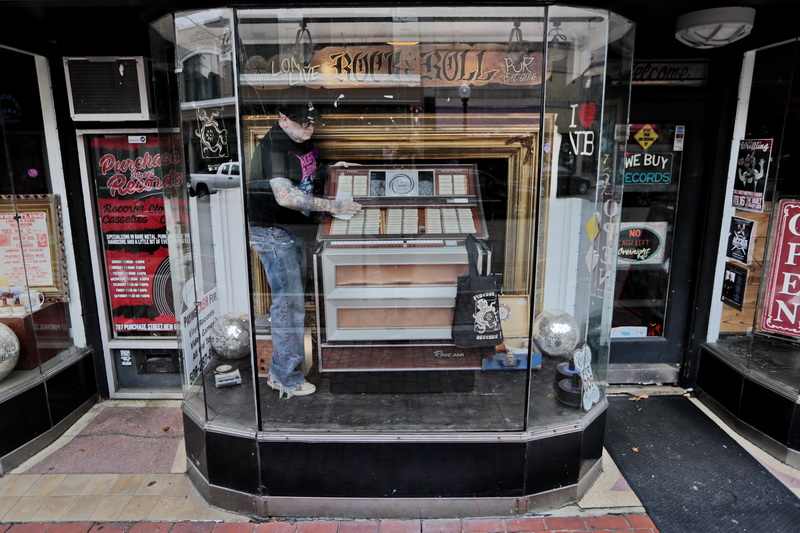 Roger Chouinard, finds himself inside the storefront of his store, Purchase Street Records, cleaning the jukebox, before opening his downtown New Bedford, MA store which  specializes in vinyl records.    