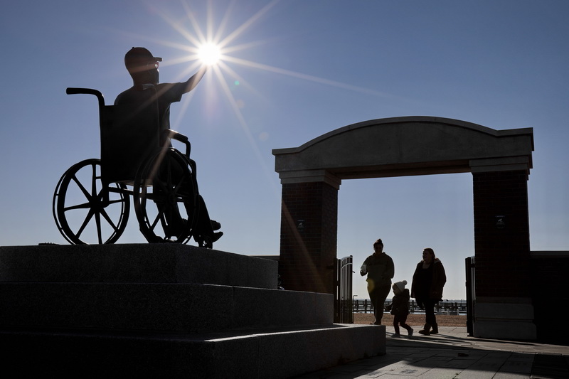 The bronze statue of Noah Fernandes seemingly holds up the sun for families walking into Noah's Place Playground on Popes Island in New Bedford.  The playground, one of the largest in New England, was made in memory of Noah Fernandes who suffered from MELS, a progressive and degenerative mitochondrial disease.   PHOTO PETER PEREIRA