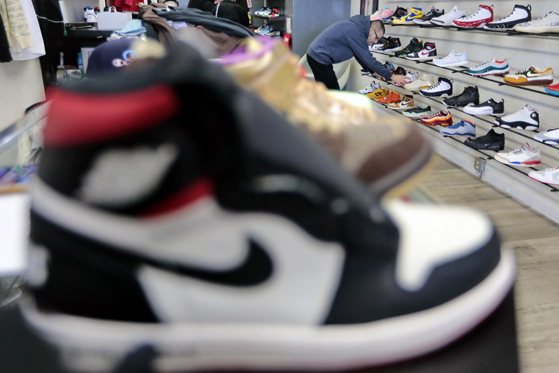 Paulo Duarte adjusts the sneakers for sale at the new location of Shop U7 on William Street in downtown New Bedford, MA.  PHOTO PETER PEREIRA