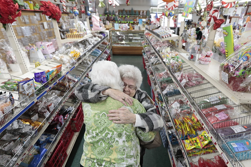 Long time customer, Cora Baker, gives owner Jaqueline Bowden a heartfelt hug after finding out that Billy Boy Candy in New Bedford, MA will be closing in April after 60 years of operation.  PHOTO PETER PEREIRA