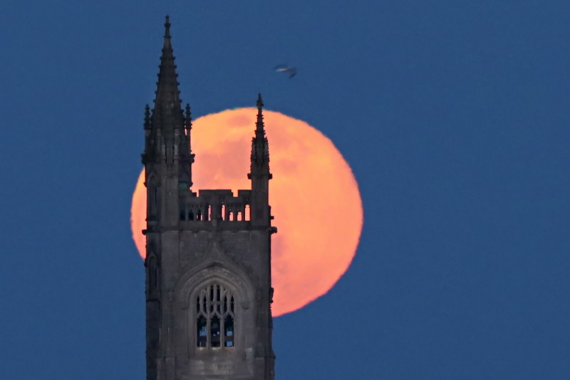 The 'Supermoon' rises behind the iconic steeple of the Unitarian Church in Fairhaven, MA.  PHOTO PETER PEREIRA