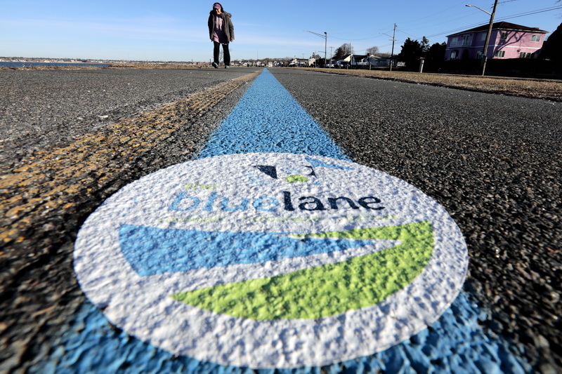 Marilyn Miller goes for a walk on the newly painted Blue Lane bike/walk path around the south end of New Bedford, MA.  PHOTO PETER PEREIRA