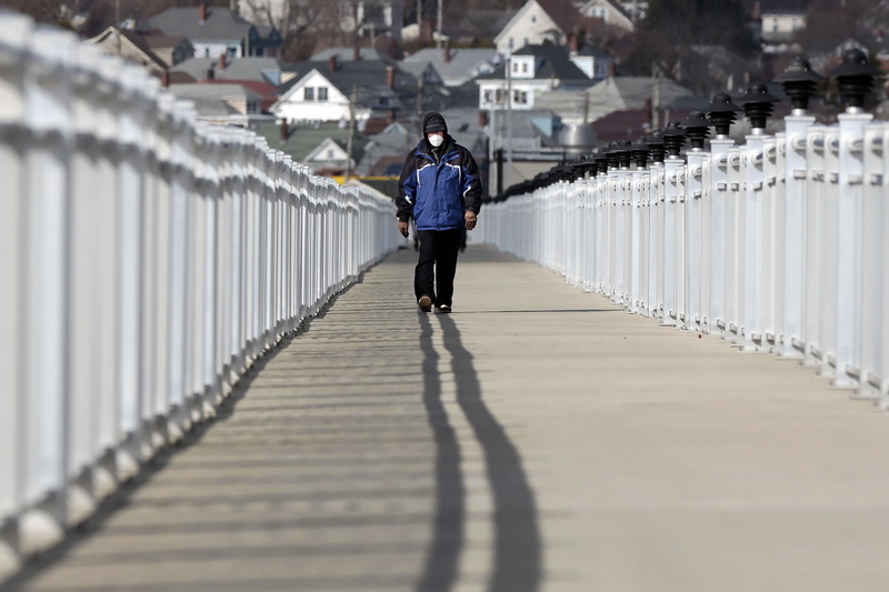 Dinis Melo tries to stay safe with a mask, as he goes for his daily walk atop the Harborview walk on the Clark's Cove side in the south end of New Bedford, MA.   PHOTO PETER PEREIRA