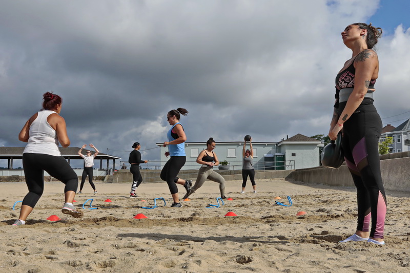 Members of the F.I.T.T. By K gym on Dartmouth Street in New Bedford are seen working out at various stations set up on East Beach in New Bedford under the guidance of Kaitlyn Duarte who plans on re-opening her gym on Monday.   PHOTO PETER PEREIRA