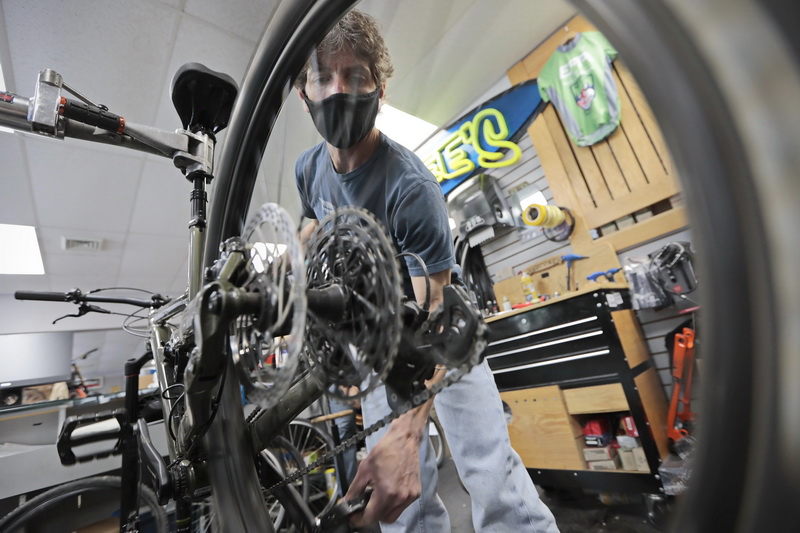 Scott Martin repairs the disk brakes on a mountain bike at his Scottee's Westport Bicycle store on Route 6 in Westport, MA.  Scott has sold every bicycle he has in stock, and is having a hard time keeping up with the record number of bike repairs he has had since the pandemic begun.   PHOTO PETER PEREIRA