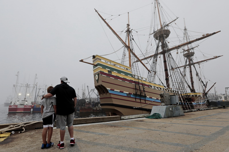 Chad Reynolds and his son Kaleb Reynolds, 9, enjoy the view of the Mayflower II at State Pier in New Bedford, MA. The Mayflower II made an unscheduled overnight stop at State Pier in New Bedford to ride out Tropical Storm Isaias. PHOTO PETER PEREIRA