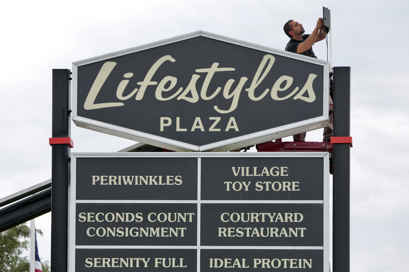 Marco Vieira of Viera Electric, installs a new electronic control panel for the Lifestyles Plaza sign on Route 6 in Fairhaven, MA.  PHOTO PETER PEREIRA