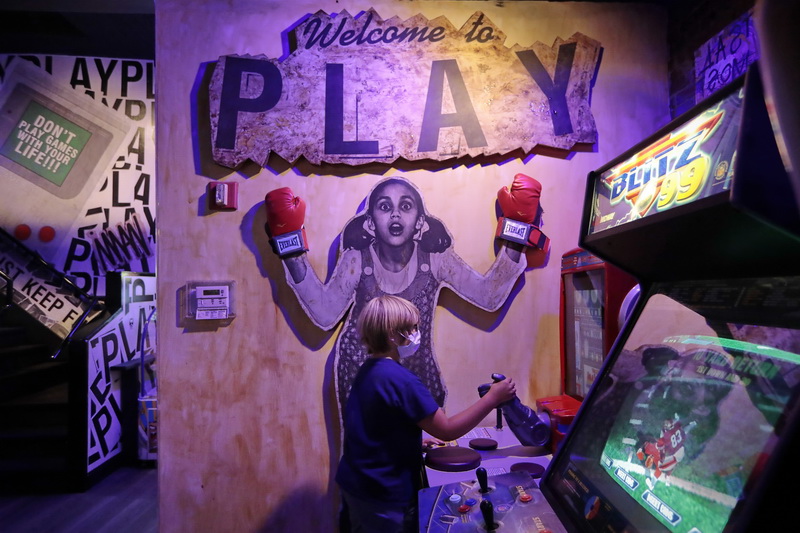 Max Cobb, 9, tries his hand at an arm wrestling video game at the new Play Arcade Bar & Restaurant on Union Street in downtown New Bedford, MA.  PHOTO PETER PEREIRA