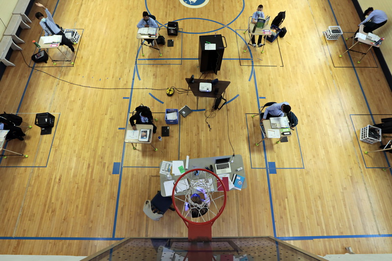 Fifth grade social studies teacher, Anna DeLong, is seen directly below the baskeball hoop as she teachers her class inside the gym of the Nativity Preparatory School on Spring Street in New Bedford, MA.  PHOTO PETER PEREIRA