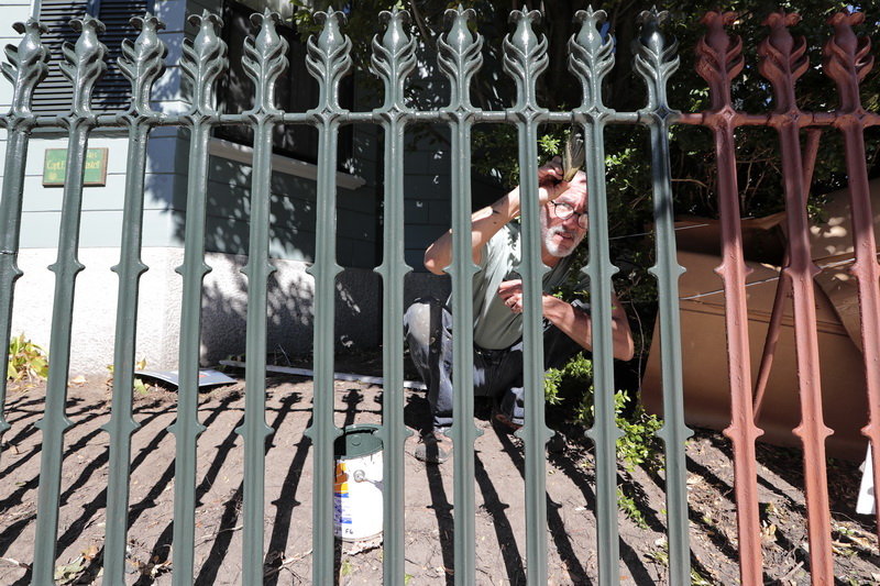 Don Wilkinson of Pequod Crew, paints the fence of an historical home on Union Street in New Bedford, MA.   PHOTO PETER PEREIRA