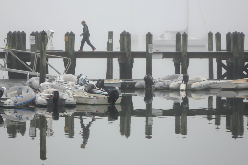 Ray Williams goes for his daily walk around the Mattapoisett, MA waterfront on a foggy morning. PHOTO PETER PEREIRA