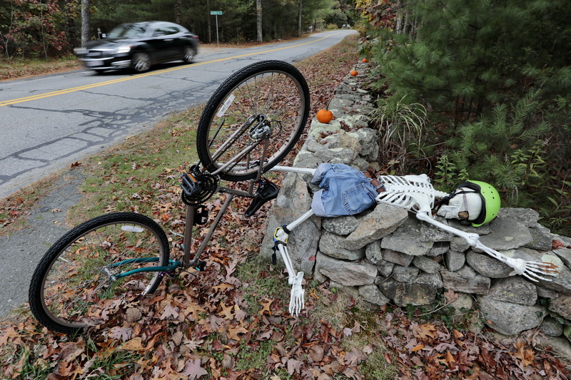 A vehicle makes its way up Potomska Road in Dartmouth, MA past a Halloween display on the side of the road.   PHOTO PETER PEREIRA