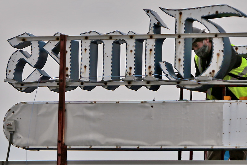 Erik Tracey and John Lemieux of Poyant Signs install new LED lights inside The Standard-Times sign at the Elm Street office in downtown New Bedford, MA. PHOTO PETER PEREIRA 