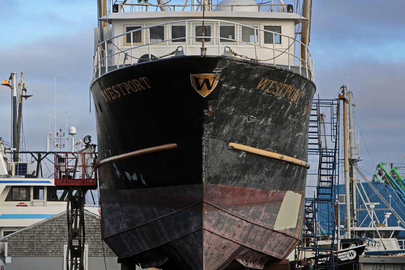 The fishing boat Westport towers above the ground, as a worker uses an air pneumatic needle scaler to remove the paint of the fishing boat at dry dock at Fairhaven Shipyard in Fairhaven, MA. PHOTO PETER PEREIRA