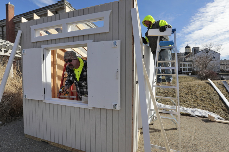 Barry Barkley and fellow New Bedford Facilities Fleet Management workers construct a kiosk at Custom House Square in New Bedford, MA. The kiosk is in support of grant funded winter placemaking and programming to take place within Wings Court and Custom House Square.  Activities will include snowmaking, a fire pit, a curling mat and the Art Mobile and programming at the CVPA Swain Studio at the corner of Purchase and Union Streets.  PHOTO PETER PEREIRA