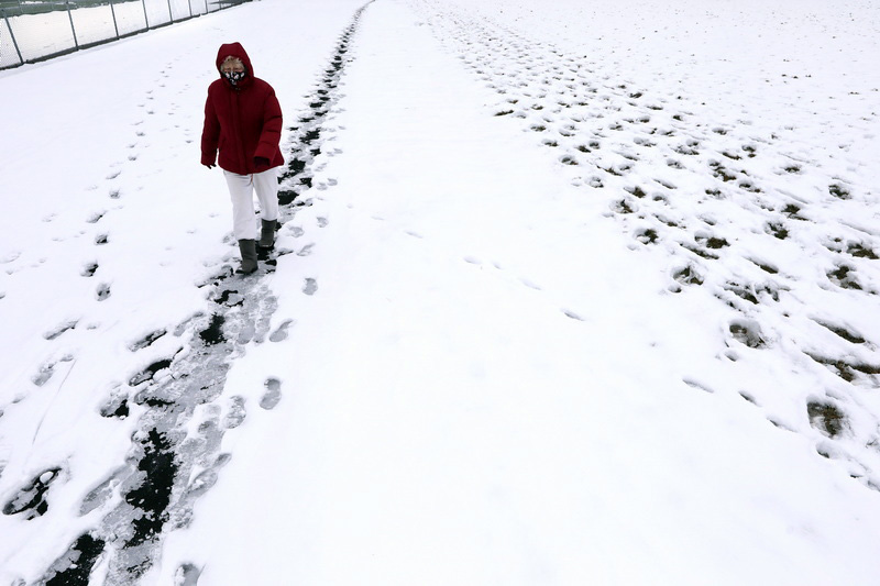 Irene Chabior goes for her daily walk around the track at Cushman Park in Fairhaven, MA sticking to the narrow footpath made by others since the recent snowfall. PHOTO PETER PEREIRA