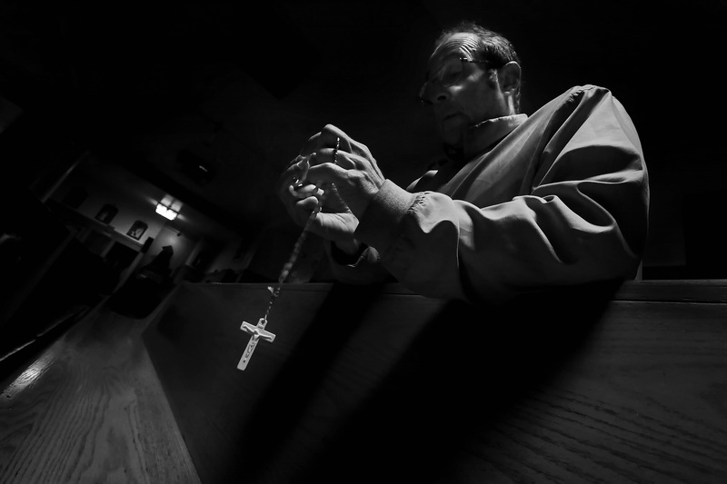 Rob Grant takes a moment to pray the rosary at Our Lady's Chapel in downtown New Bedford, MA on Holy Thursday leading up to Easter Sunday. PHOTO PETER PEREIRA