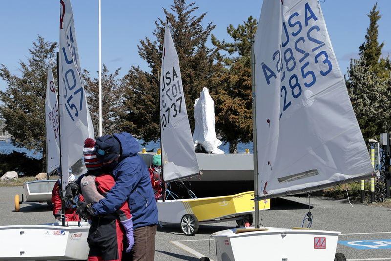 Cutter Smith gives his son Wylder Smith, 12, a hug before he heads out with fellow JK Sailing Team members into Marion, MA harbor to prepare for the upcoming United States Team trials being held in Texas in two weeks. PHOTO PETER PEREIRA